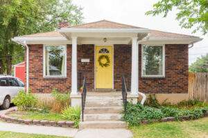 Home insurance for a Frankenmuth, MI, brick house with a yellow door