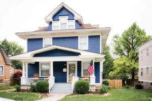 House insurance in Saginaw, protected with homeowners policy for two story house in navy blue siding